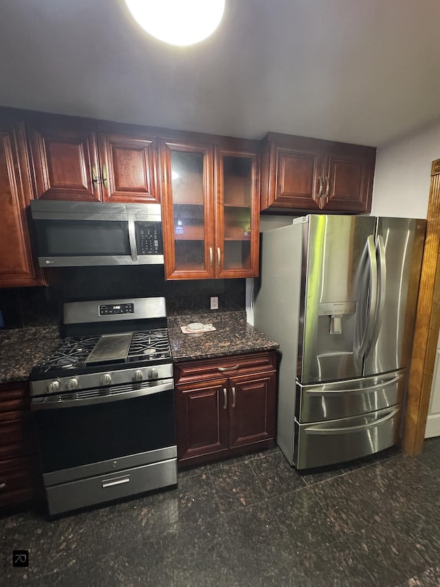 1264 E 73rd St, New York City, NY 11234 - kitchen featuring appliances with stainless steel finishes, glass insert cabinets, and dark brown cabinets