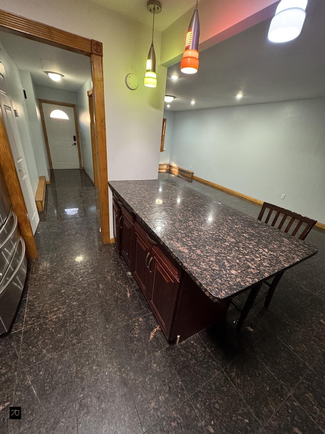 1264 E 73rd St, New York City, NY 11234 - kitchen featuring baseboards, dark countertops, granite tiled floors, and hanging light fixtures