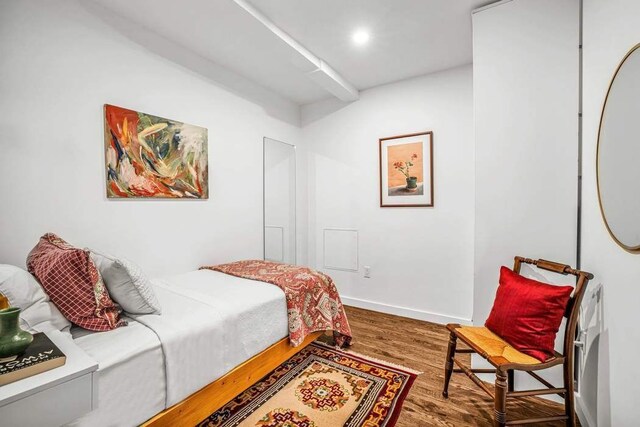 bedroom featuring baseboards and wood finished floors