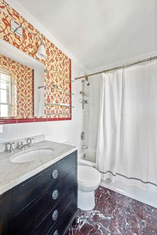 full bath featuring tile walls, vanity, toilet, marble finish floor, and shower / bathtub combination with curtain