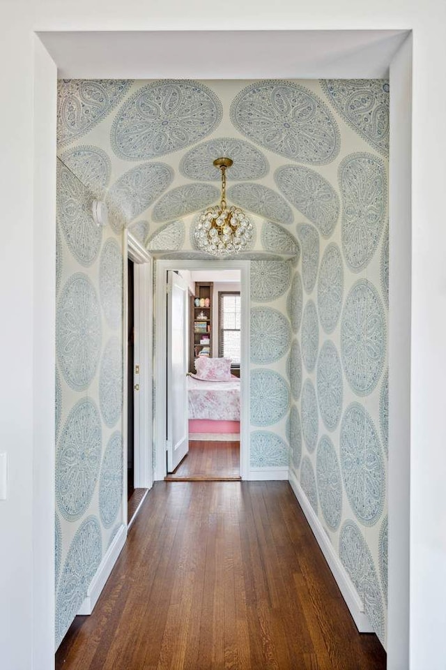 hall with baseboards and hardwood / wood-style floors
