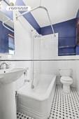 bathroom featuring tile patterned flooring, a bath, toilet, and a shower