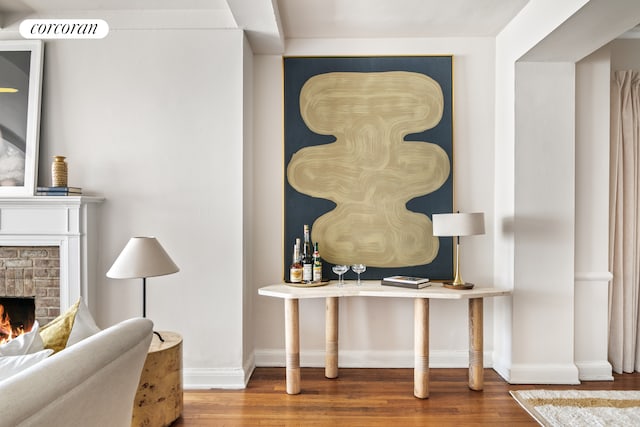 400 E 52nd St Unit 12Ff, New York City, NY 10022 - detailed view of wood finished floors, baseboards, and a brick fireplace