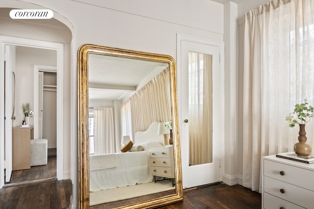 bedroom with dark wood-style flooring, baseboards, and visible vents