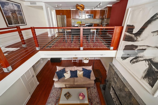 interior space featuring visible vents, track lighting, and wood finished floors