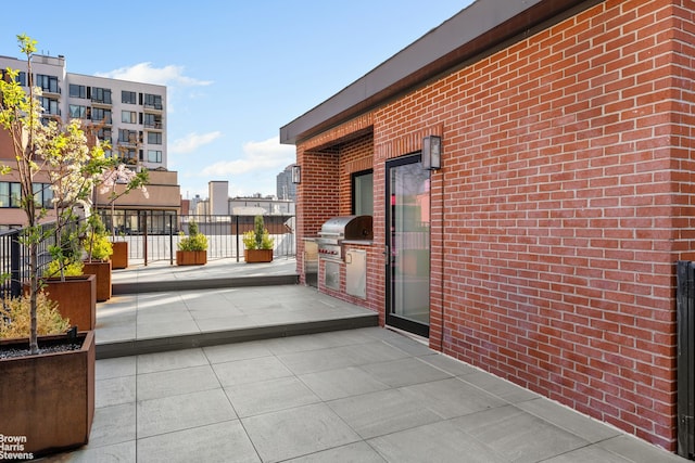 49 E 126th St, New York City, NY 10035 - view of patio with an outdoor kitchen and a grill