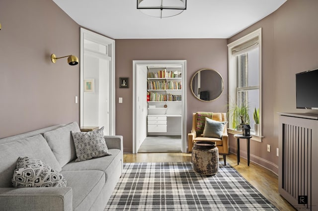 living room with baseboards and wood finished floors