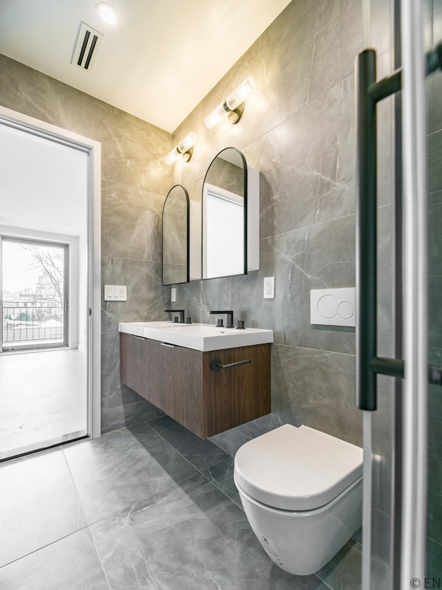 636 Lorimer St Unit 2, New York City, NY 11211 - bathroom featuring tile walls, double vanity, and toilet