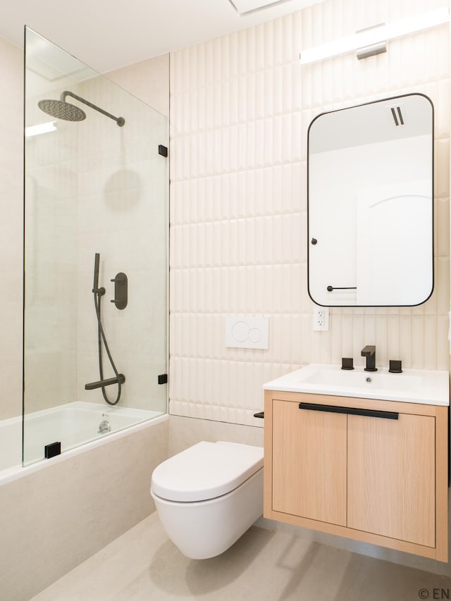 636 Lorimer St Unit 2, New York City, NY 11211 - full bath featuring vanity, tile walls, tiled shower / bath combo, and toilet