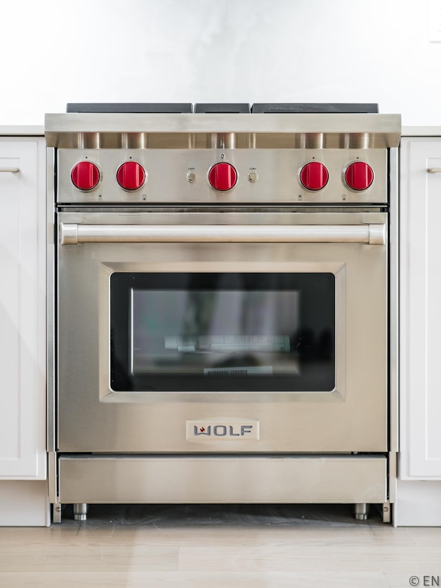 details with white cabinetry and designer range