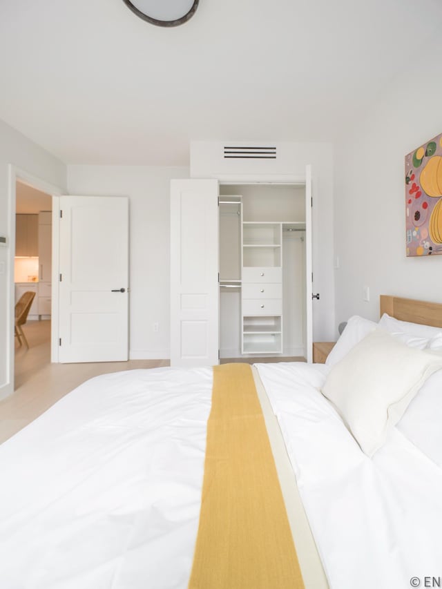 bedroom featuring visible vents and a closet