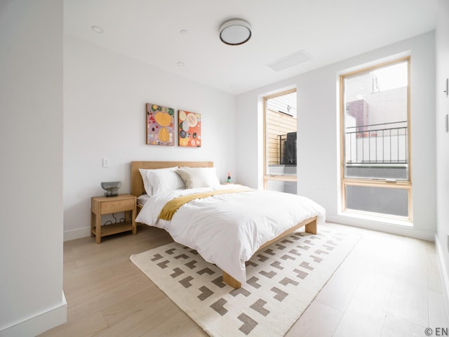 bedroom with baseboards and light wood-style flooring
