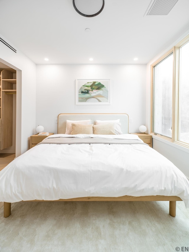 bedroom featuring recessed lighting, visible vents, and multiple windows