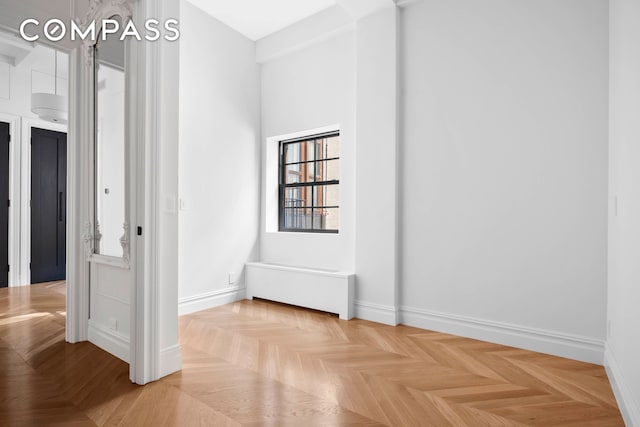 unfurnished room featuring baseboards
