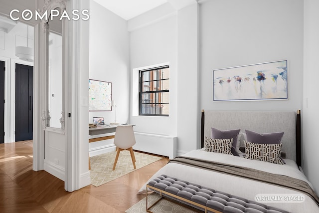 bedroom featuring baseboards and a towering ceiling