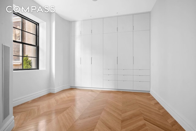 spare room with baseboards