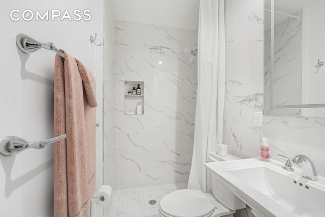 full bathroom with a sink, a stall shower, and toilet