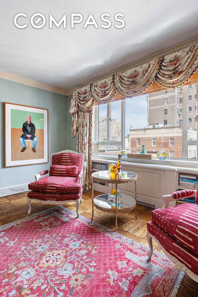 sitting room featuring ornamental molding and a city view