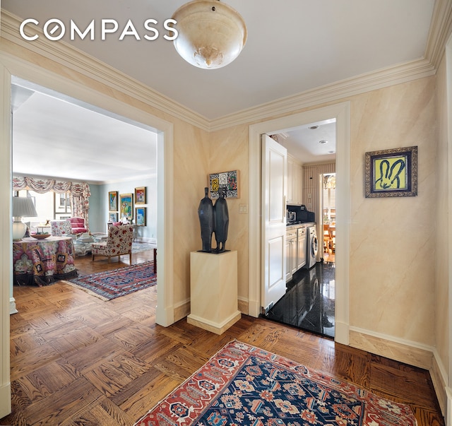 hall with baseboards, washing machine and dryer, ornamental molding, and plenty of natural light