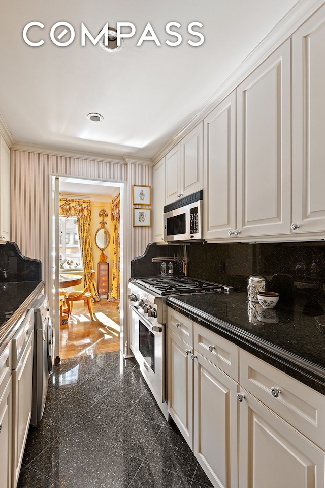 kitchen with separate washer and dryer, wallpapered walls, appliances with stainless steel finishes, and granite finish floor