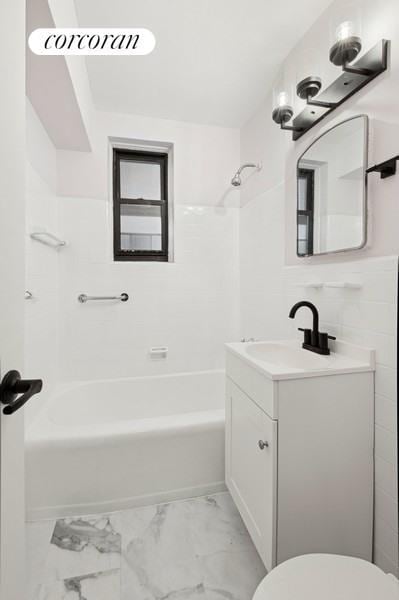 full bathroom featuring toilet, tub / shower combination, marble finish floor, and vanity