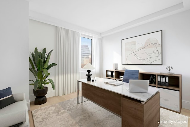 home office with light wood-style flooring