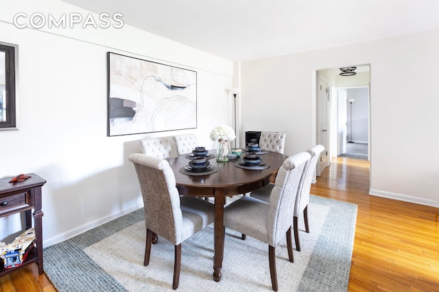 dining area featuring baseboards and wood finished floors