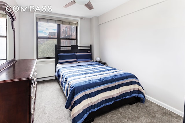 carpeted bedroom with baseboards and ceiling fan