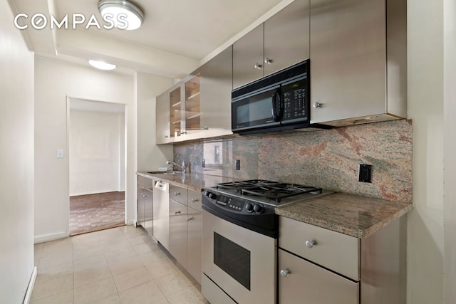 1025 5th Ave Unit 7As, New York City, NY 10028 - kitchen with appliances with stainless steel finishes, backsplash, baseboards, light tile patterned floors, and a sink