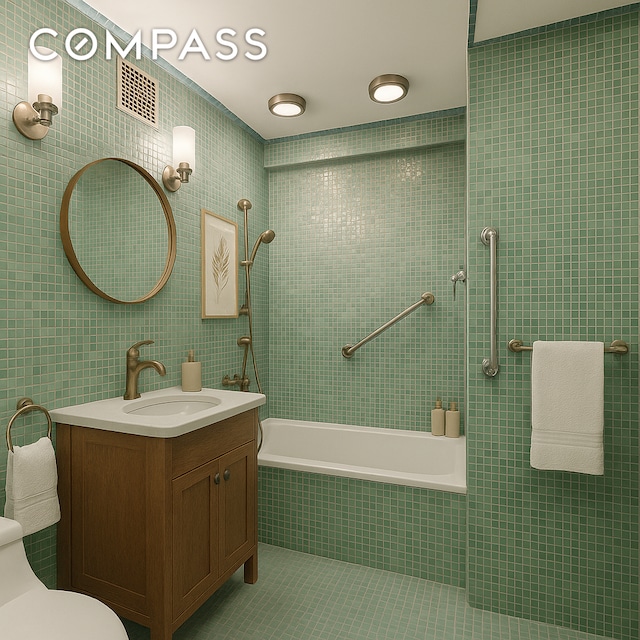 1025 5th Ave Unit 7As, New York City, NY 10028 - full bathroom featuring tile walls, tile patterned flooring, toilet, tiled shower / bath combo, and vanity