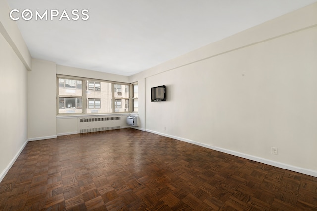 1025 5th Ave Unit 7As, New York City, NY 10028 - empty room featuring radiator heating unit, baseboards, and a wall unit AC
