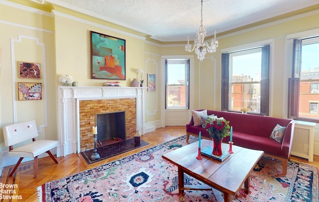 188 W 135th St Unit 5W, New York City, NY 10030 - living room featuring crown molding, a chandelier, a textured ceiling, a fireplace, and baseboards