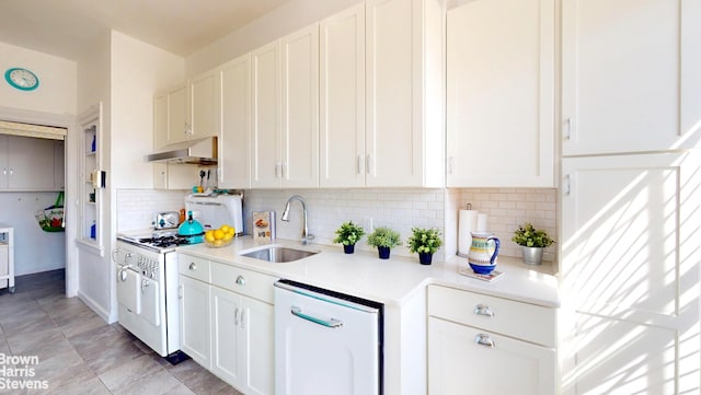 188 W 135th St Unit 5W, New York City, NY 10030 - kitchen featuring under cabinet range hood, white appliances, a sink, light countertops, and white cabinetry