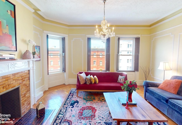 188 W 135th St Unit 5W, New York City, NY 10030 - living area with a textured ceiling, a chandelier, ornamental molding, and a brick fireplace