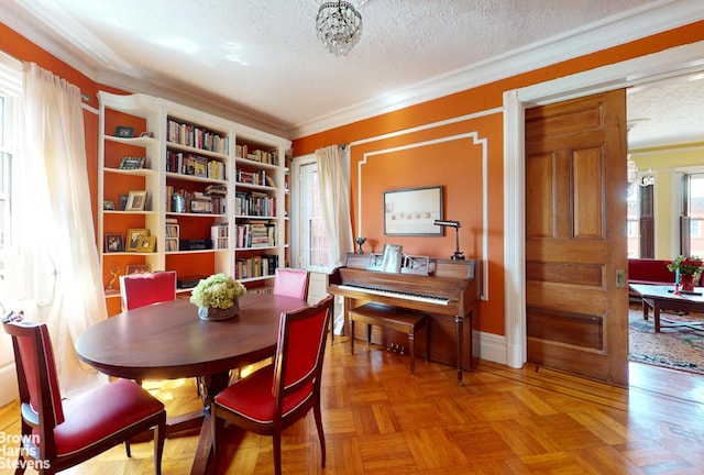 188 W 135th St Unit 5W, New York City, NY 10030 - dining area featuring a textured ceiling, crown molding, and a chandelier