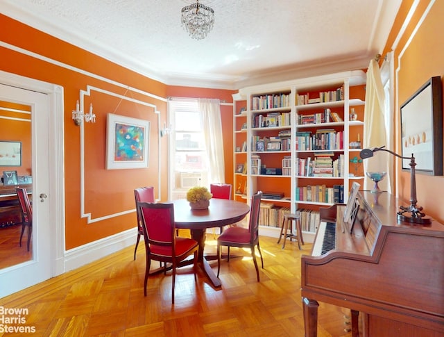 188 W 135th St Unit 5W, New York City, NY 10030 - dining space featuring a textured ceiling, crown molding, a chandelier, cooling unit, and baseboards