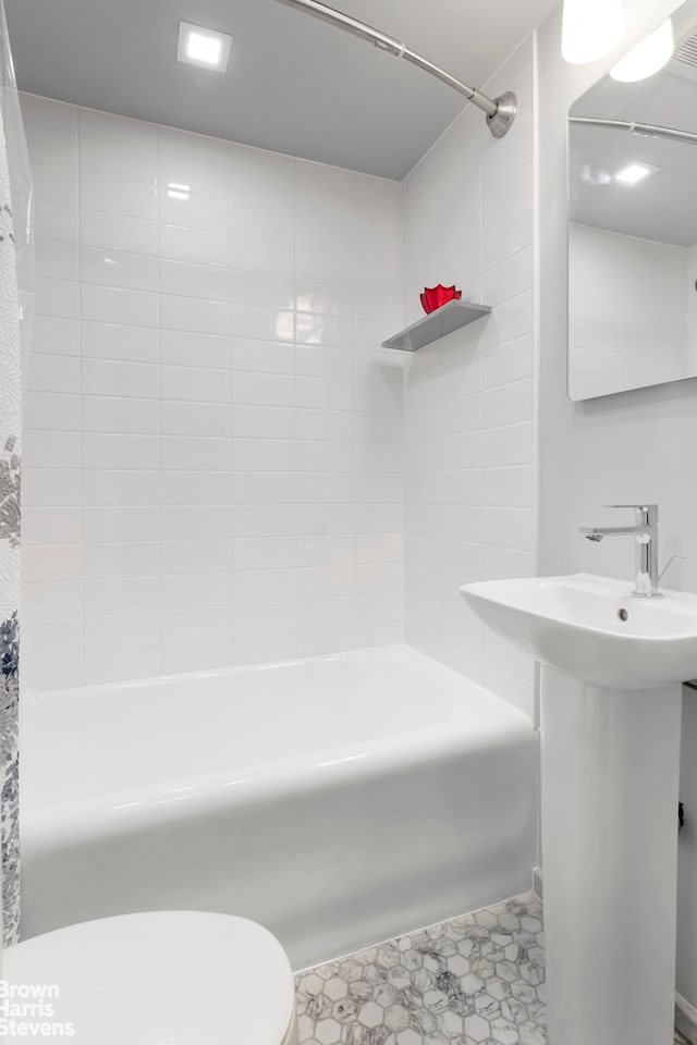 full bathroom with toilet, a sink, and shower / tub combo