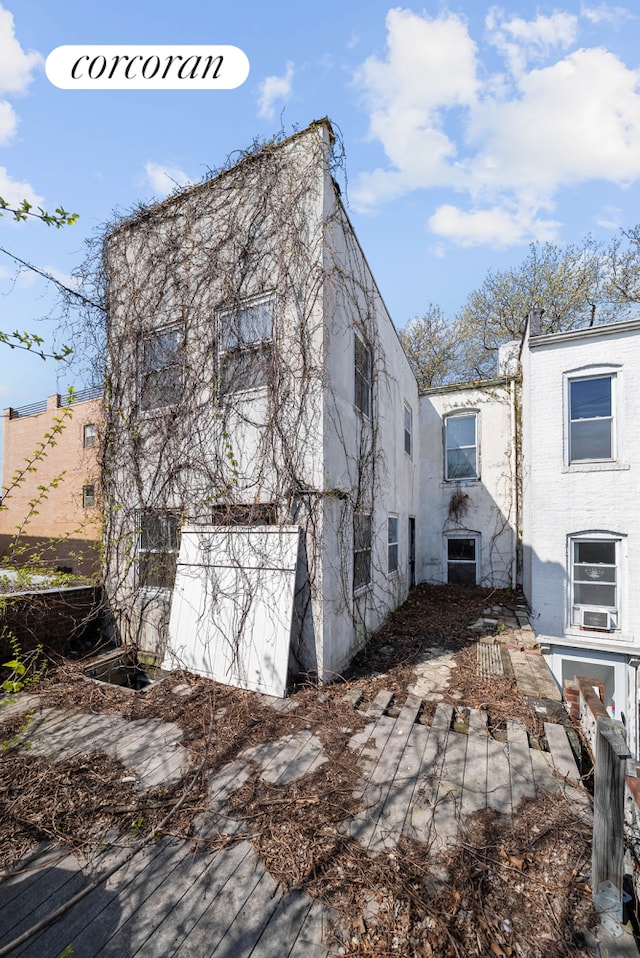 125 Stryker St, New York City, NY 11223 - rear view of property featuring stucco siding