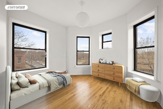 bedroom featuring light wood-style floors, baseboards, and visible vents