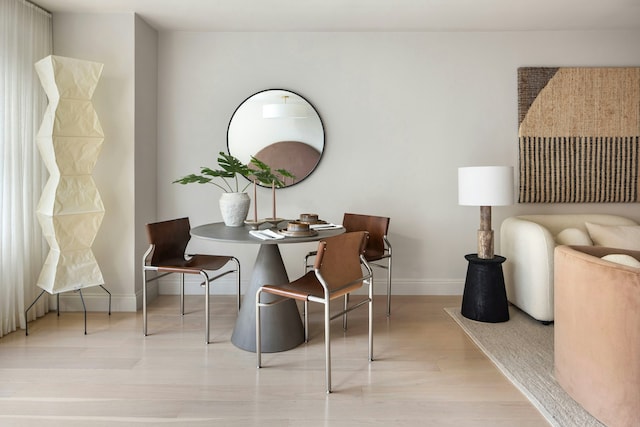living area featuring baseboards and wood finished floors