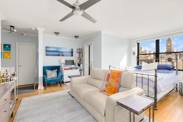 bedroom with ceiling fan, ornamental molding, and light wood-type flooring