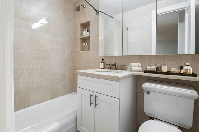 bathroom featuring backsplash, toilet,  shower combination, and vanity