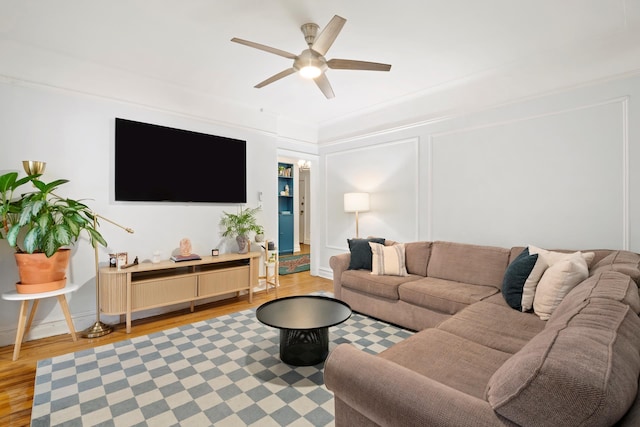living room with light wood-type flooring and a ceiling fan