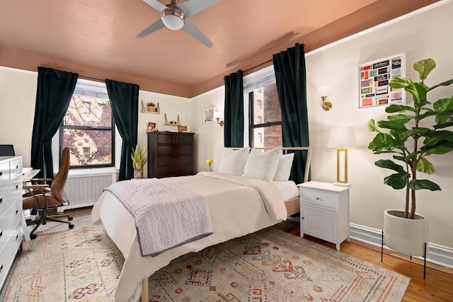 bedroom featuring baseboards and light wood-type flooring