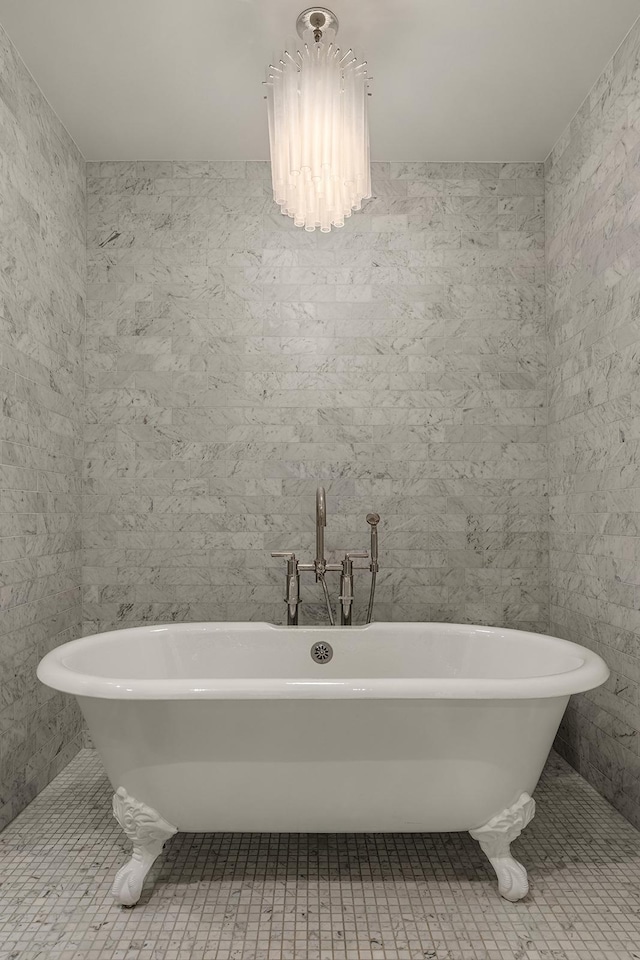 bathroom featuring a freestanding tub and tile patterned floors
