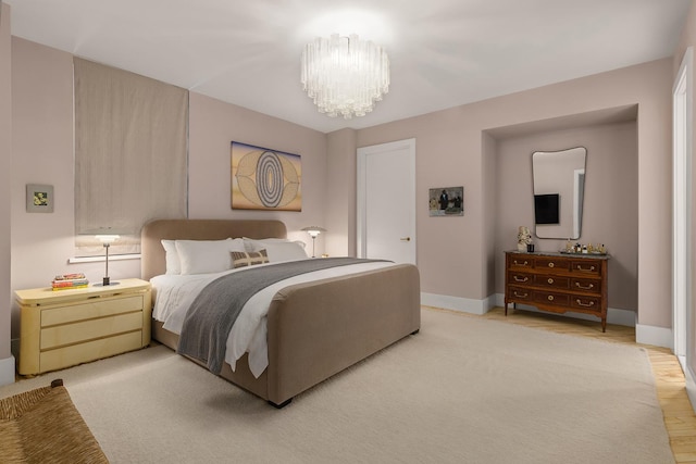 bedroom featuring baseboards and a chandelier