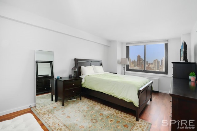 515 E 72nd St Unit 24A, New York City, NY 10021 - bedroom featuring wood finished floors and baseboards