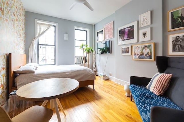 186 E 2nd St Unit 2, New York City, NY 10009 - bedroom featuring wood finished floors, baseboards, ceiling fan, and cooling unit