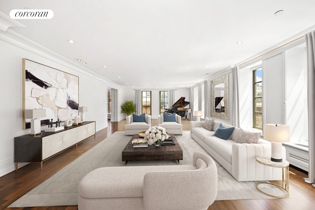 living room with ornamental molding, recessed lighting, wood finished floors, and visible vents