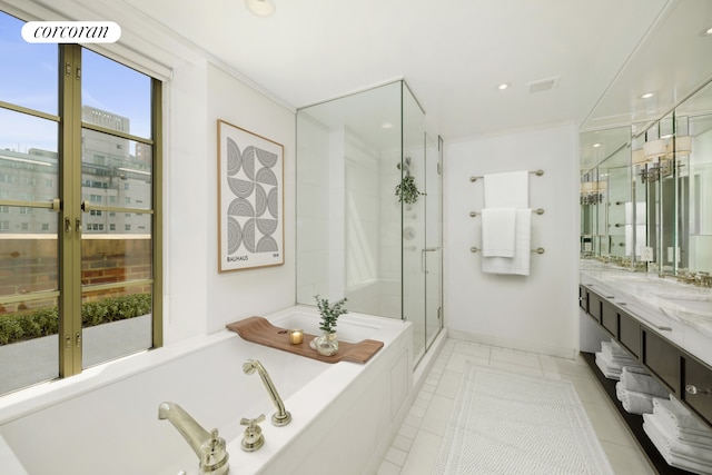 full bath with vanity, crown molding, baseboards, a bath, and a stall shower